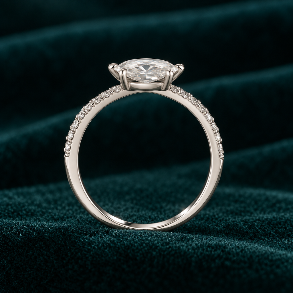 Alba ring with a level oval stone and pavé band on deep teal velvet
