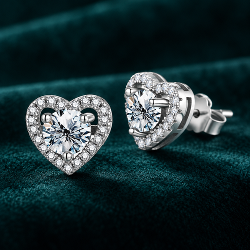 Anouk Heart Halo Earrings: pair of sterling silver heart halo stud earrings with round centre stones on teal velvet