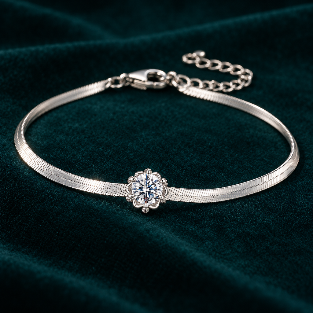 Elara Chain Bracelet: slim sterling silver herringbone chain bracelet with a single moissanite centre stone on teal velvet