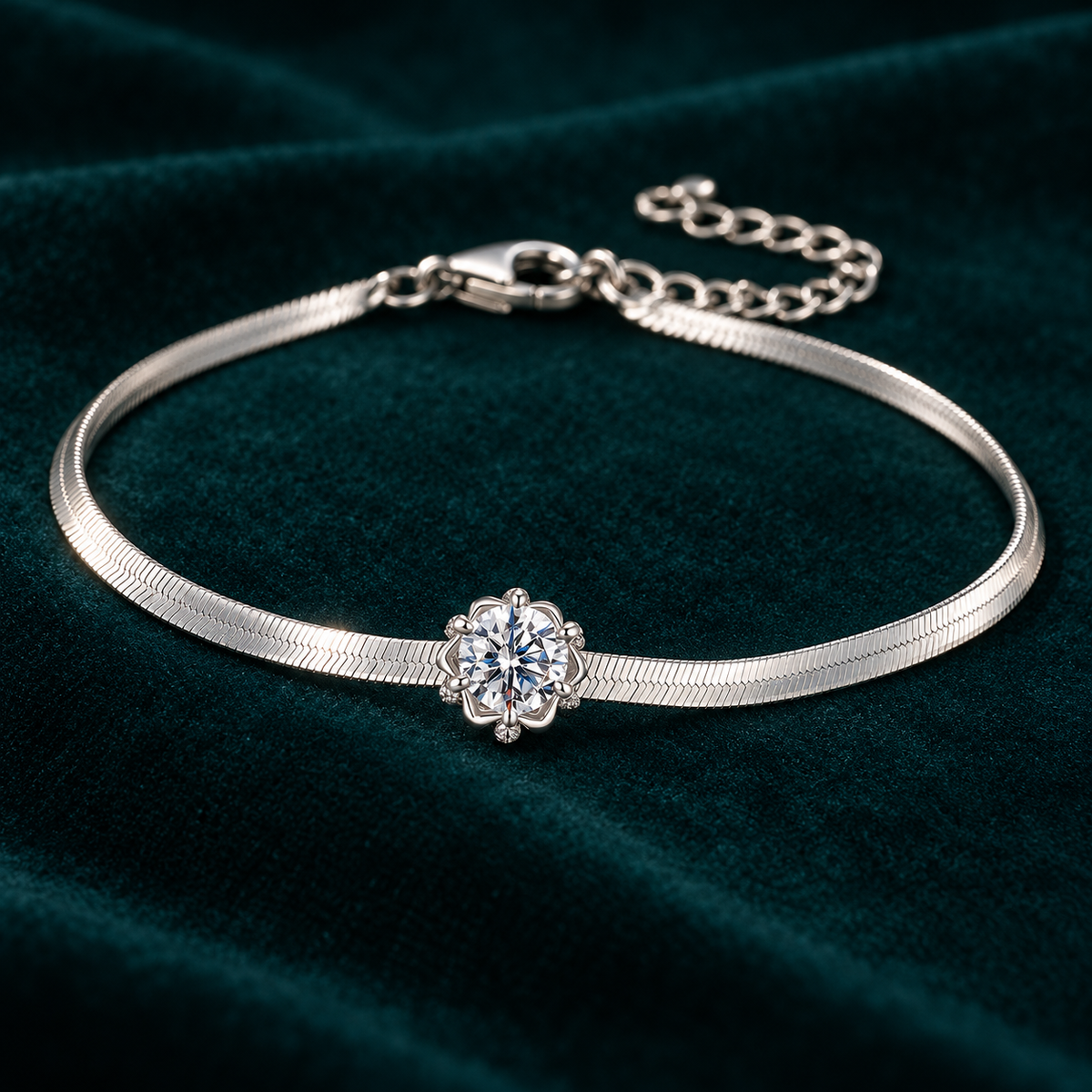 Elara Chain Bracelet: slim sterling silver herringbone chain bracelet with a single moissanite centre stone on teal velvet