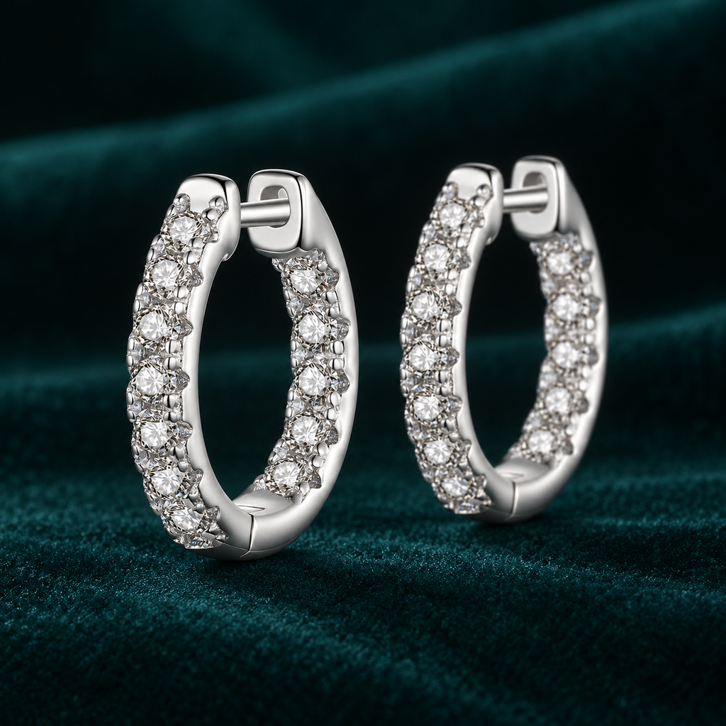 Thalia Hoop Earrings: sterling silver hoops with a row of claw-set round moissanite stones on teal velvet